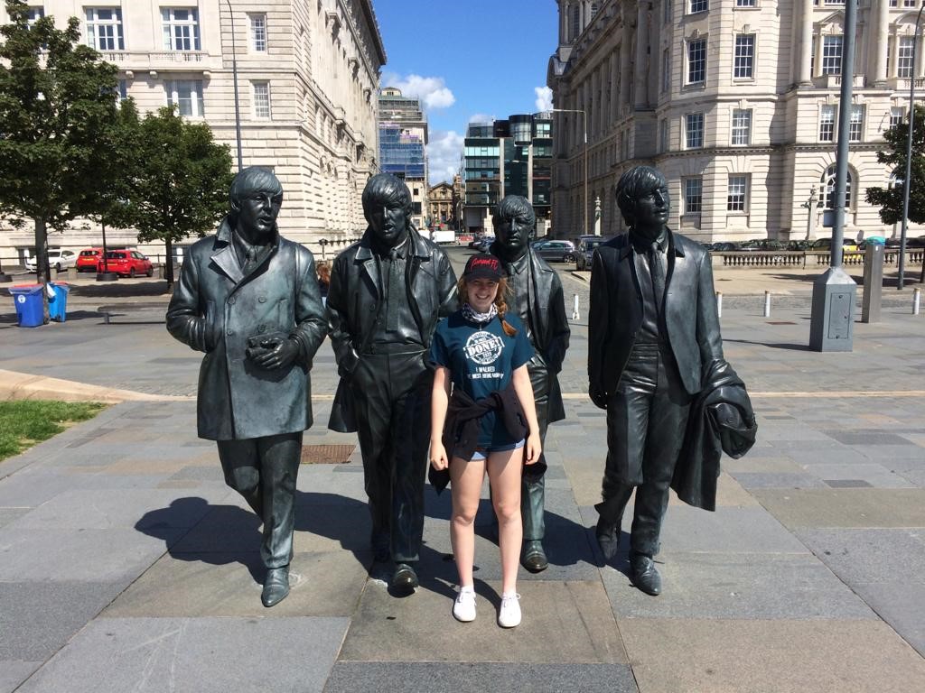 Image of Ellie Owens and a statue of the Beatles