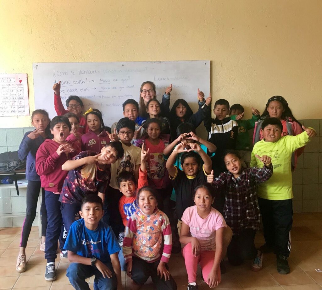 Image of Emily Jacobs and a class of children in Ecuador