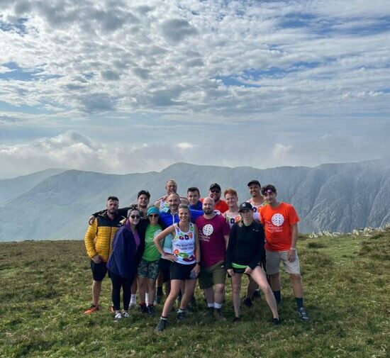 Image of Chris Webster (L 97) and his fundraising team on top of the Coniston Old Man