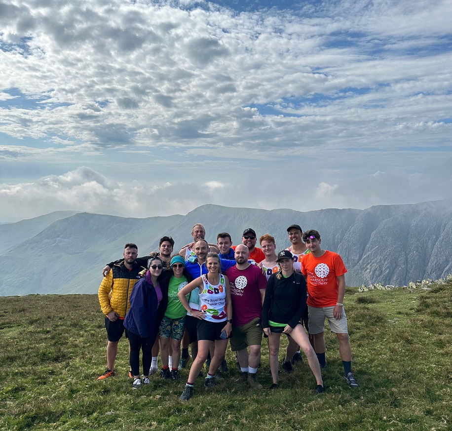 Image of Chris Webster (L 97) and his fundraising team on top of the Coniston Old Man